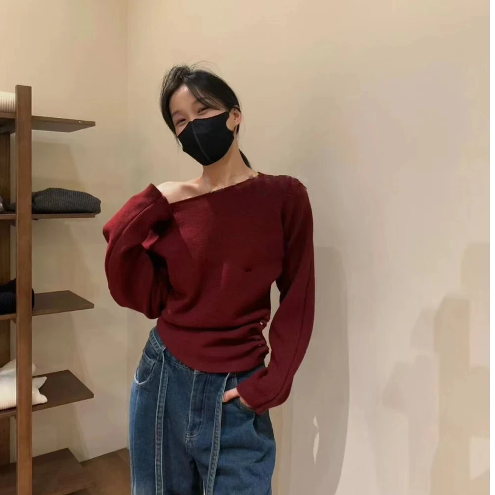 秋冬季加厚收腰排扣设计感斜肩毛衣气质小众显瘦长袖针织衫上衣女