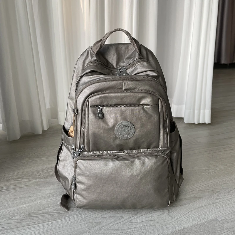 时尚休闲双肩包百搭大学生书包女轻便金属质感电脑包男潮流大背包