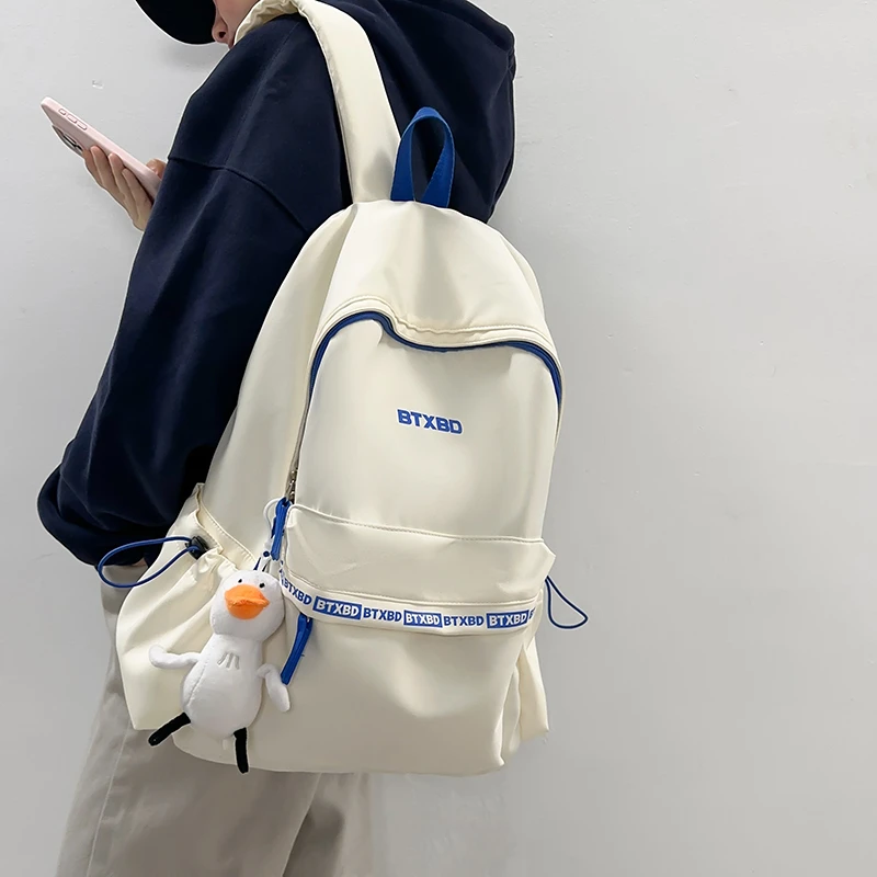 休闲纯色男女生背包韩版初中生高中小学生轻便减负书包旅行双肩包