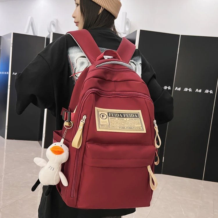 新款书包女大学生高中生中学生少女双肩包简约减负大容量男生背包