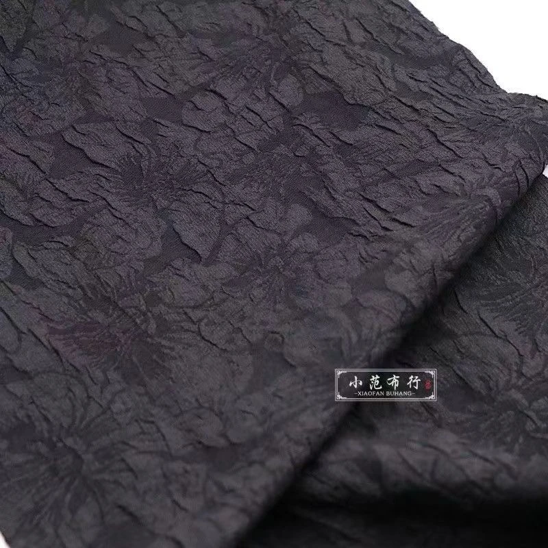 纯黑色立体泡泡提花布料抗皱浮雕立体感旗袍连衣裙设计师面料百合