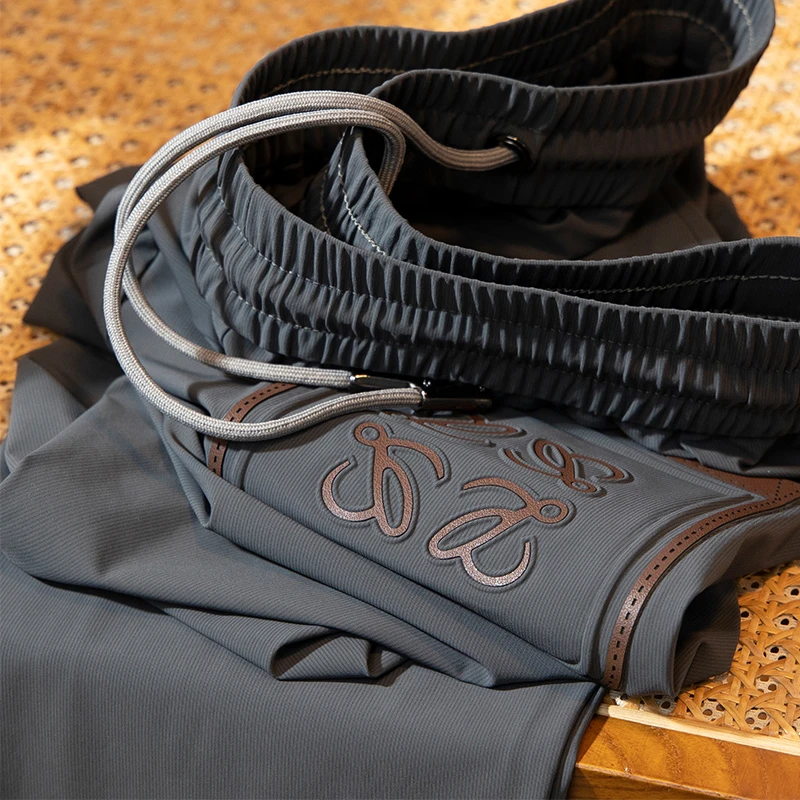 轻奢级夏季薄款冰丝滑料弹力休闲裤男修身小脚高端欧货运动裤男士