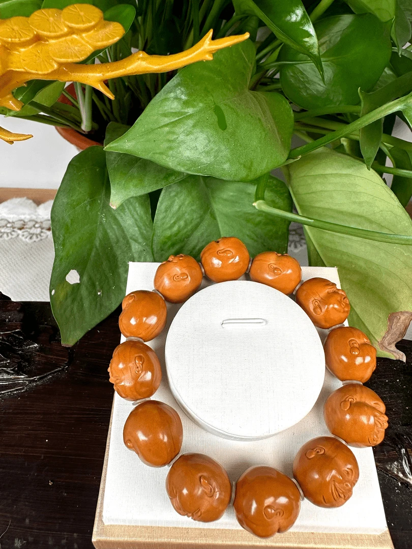 XJ百态橄榄核雕手串