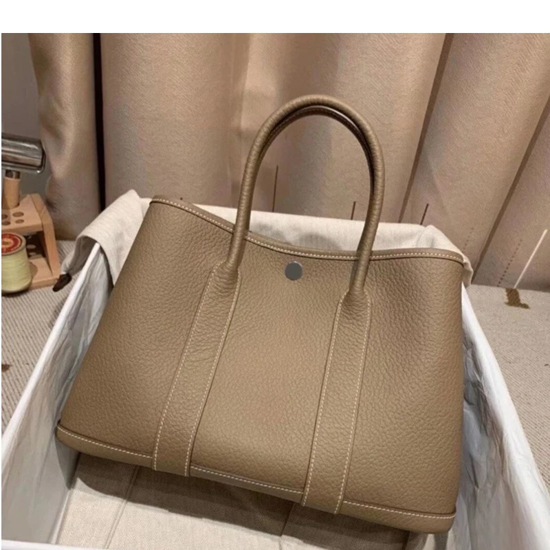 手提气质花园包包2025新款花园包水桶包商务手提通勤女包托特包