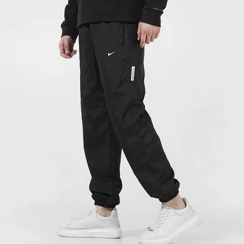 Nike耐克男裤秋冬加绒保暖跑步宽松梭织运动休闲长裤DA6737-010