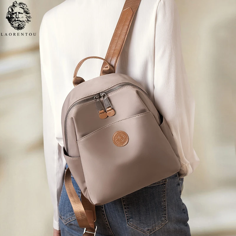 双肩包女款爆款2025新款尼龙布配牛皮防泼水轻便户外旅游小型背包