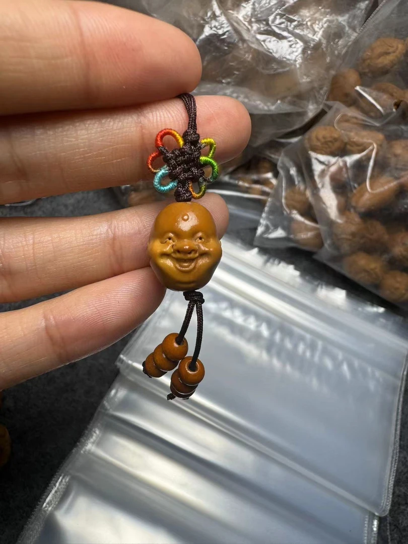 橄榄核雕十分开心单籽男女士文玩