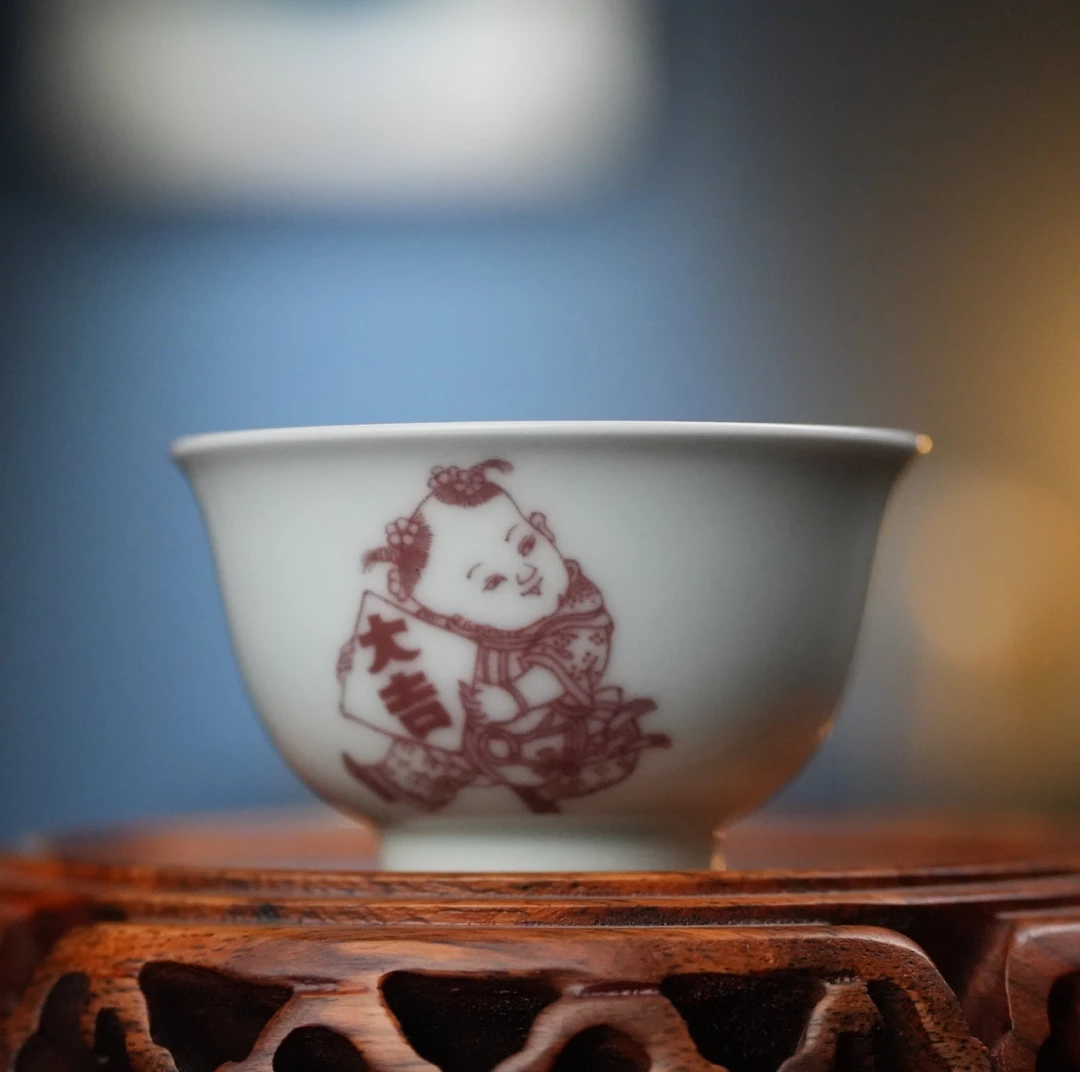 二亭.釉里红福娃迎春撇口杯