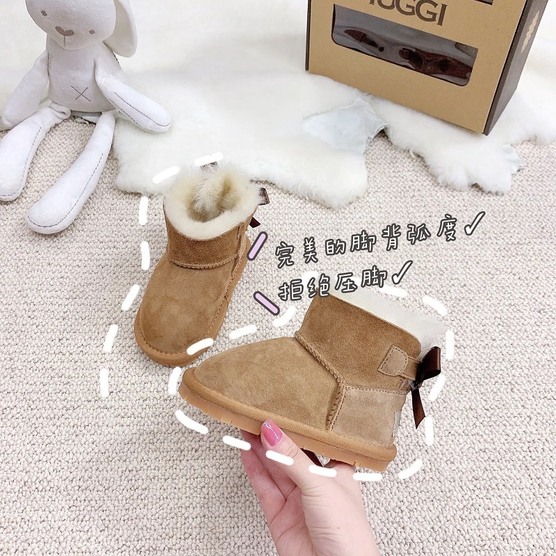 新款蝴蝶结儿童雪地靴羊皮毛一体保暖防滑婴儿学步鞋秋冬软底短筒