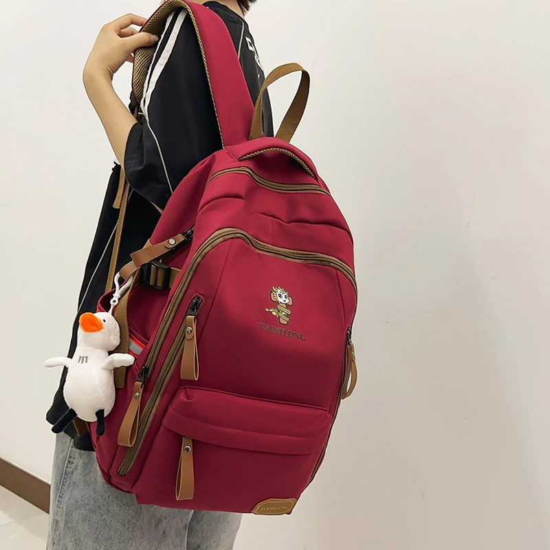 高颜值减负护脊书包女初中生高中学生大容量双肩包大学生旅行背包