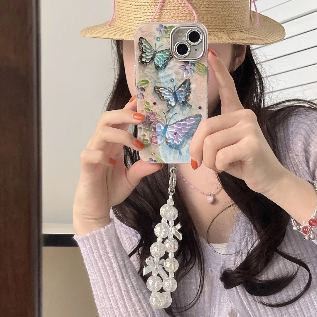 【适用苹果】iPhone15/16防摔点钻紫蓝蝴蝶花朵女手链新款手机壳