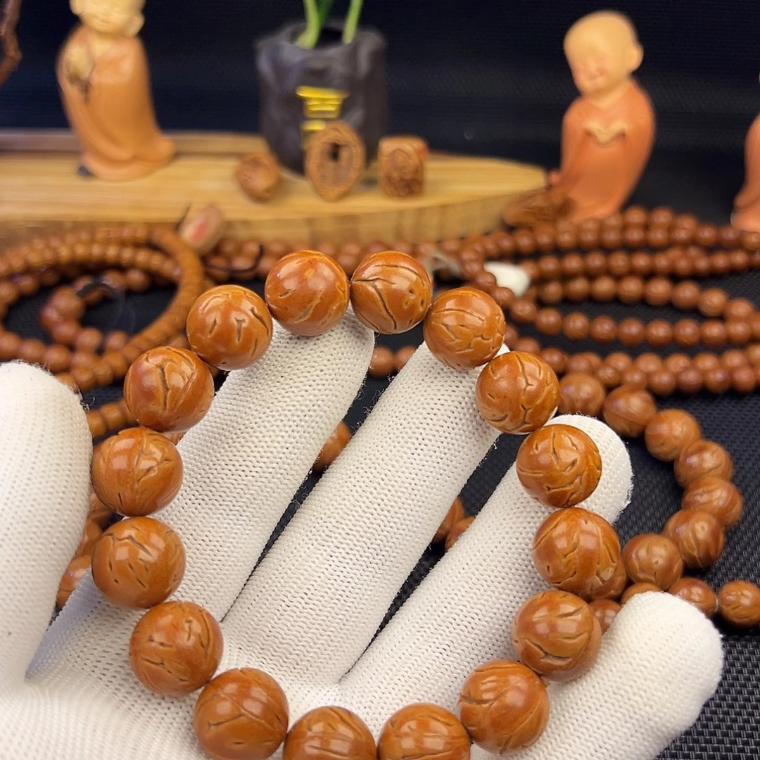 斌***仔野生龙纹桃核光珠