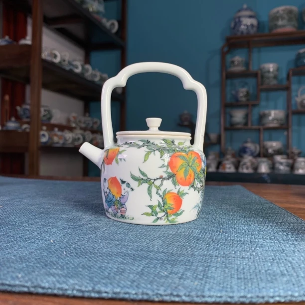 青远柴窑釉下五彩童子捧寿提梁壶