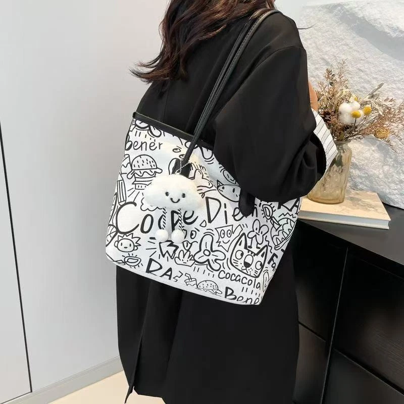 涂鸦帆布包包女2025新款休闲单肩包百搭大容量学生上课通勤托特