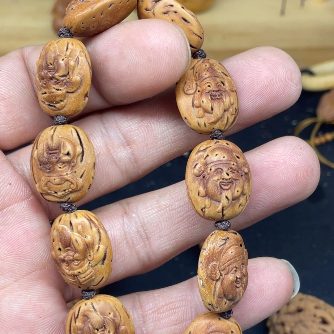 桃核雕刻财神头手串