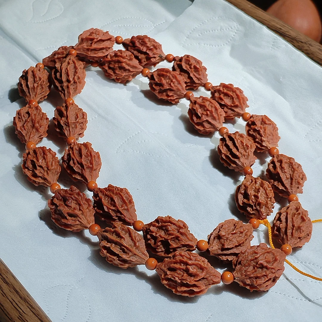 印尼野生异型橄榄核同树籽麒麟眼26颗手持把玩佳品