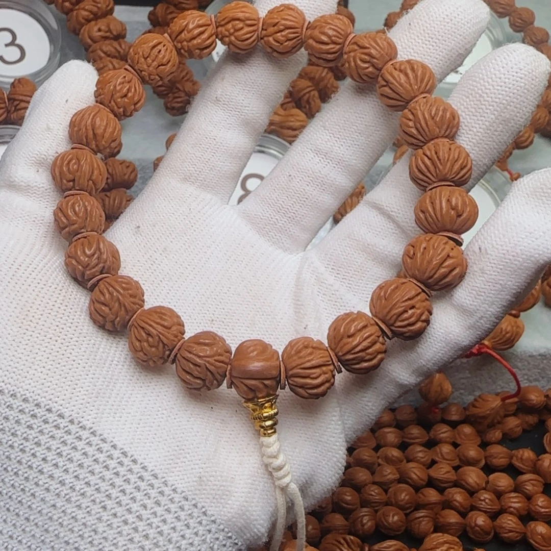 稻***人手串桃核金豆手串