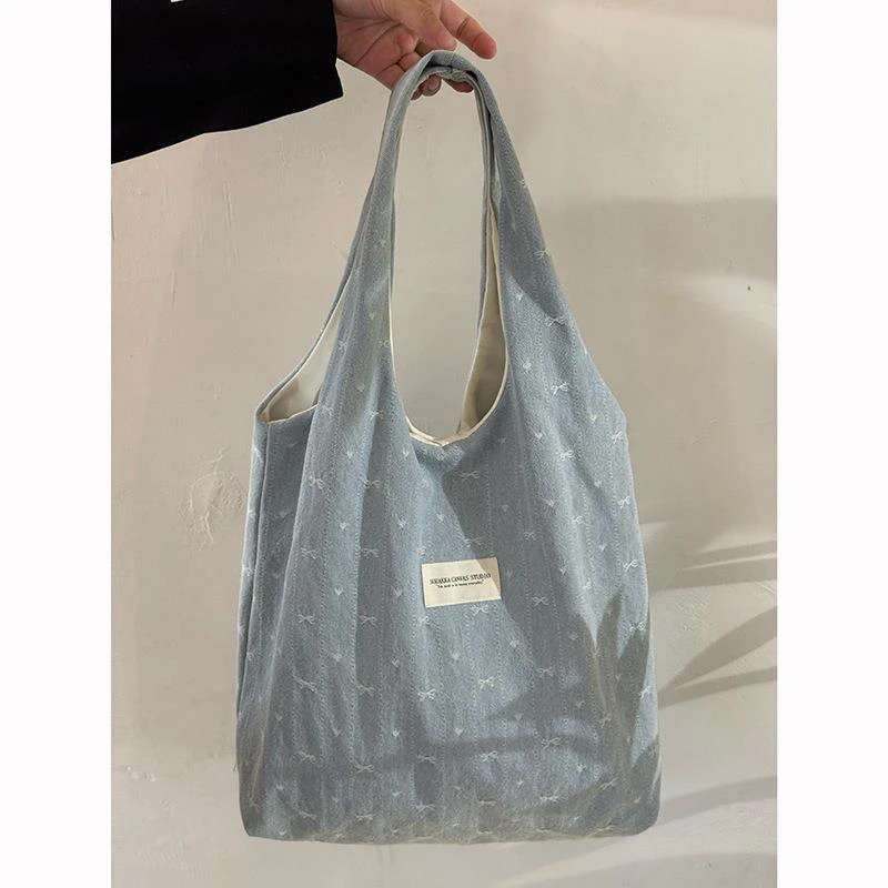 韩系蝴蝶结刺绣帆布包包女2025大容量通勤学生上课单肩托特包