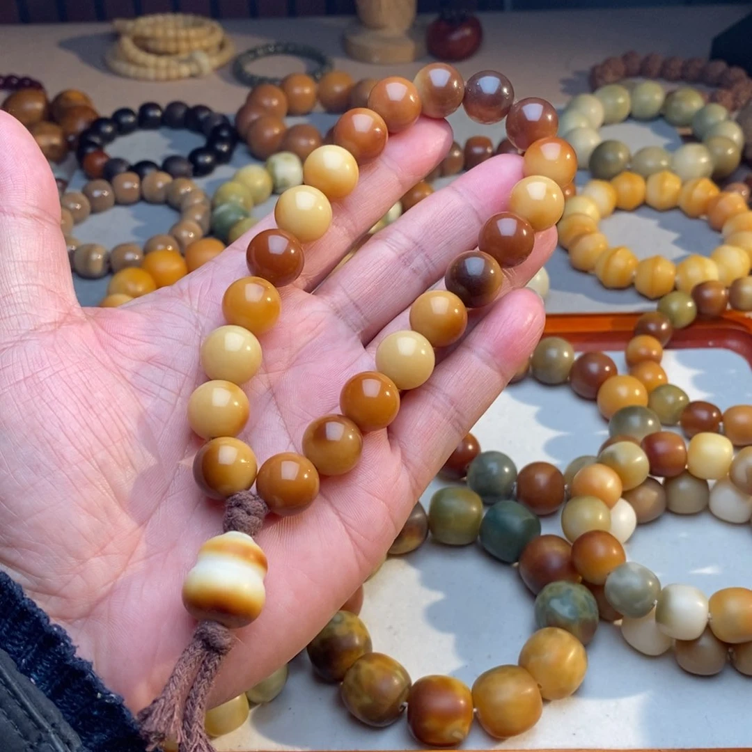 菩提根/象牙果吊坠瘦****斤14mm圆珠花咖手持