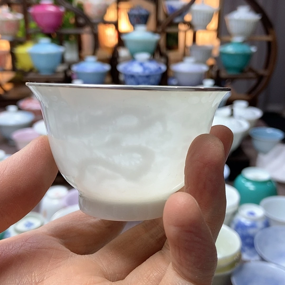 ?微瑕脱胎瓷高温手工超薄胎内模印暗刻四海游龙主人杯包银口