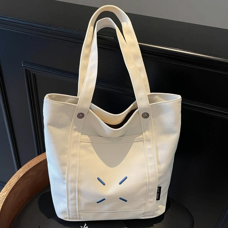 大容量托特包包女2025新款刺绣帆布上课通勤包小众百搭休闲单肩包