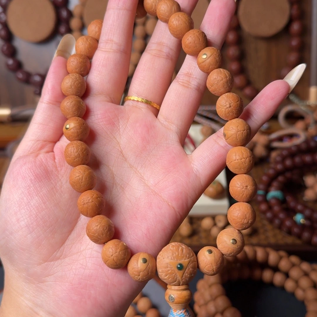 凤眼菩提把件12mm/27颗手持/铜钉