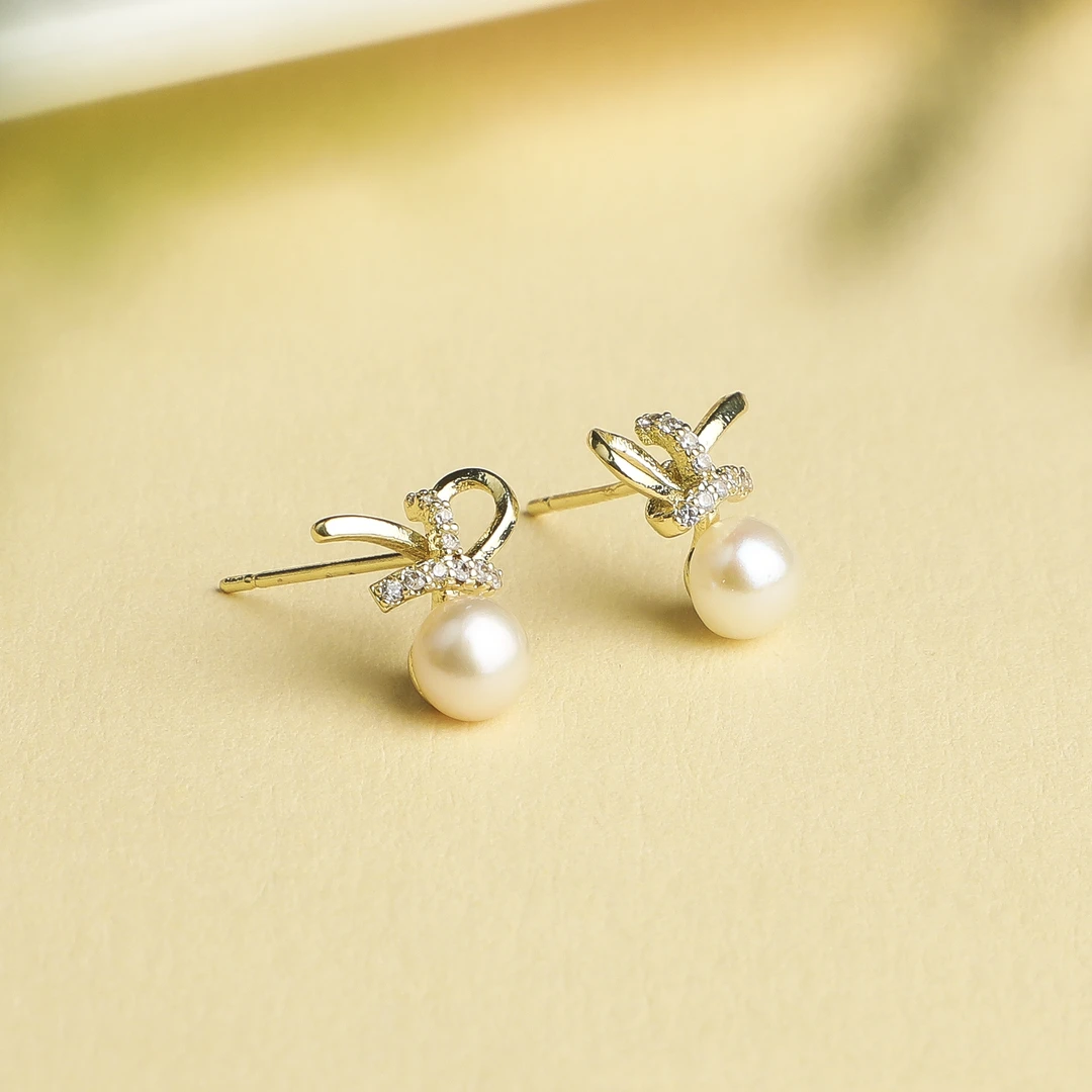 （桃）天然淡水珍珠蝴蝶结S925银耳钉