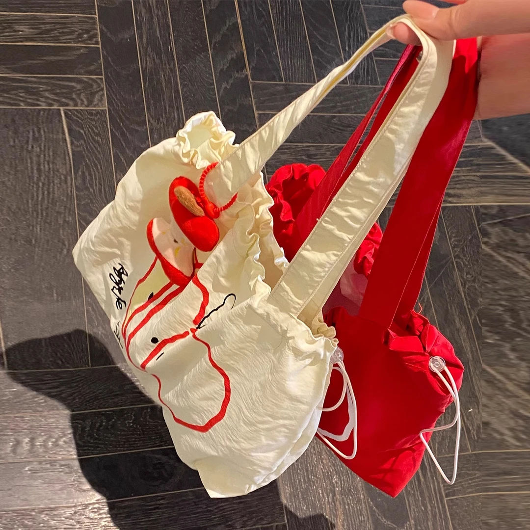 创意苹果抽绳帆布包2025新款大容量单肩包学生上班通勤手提托特包