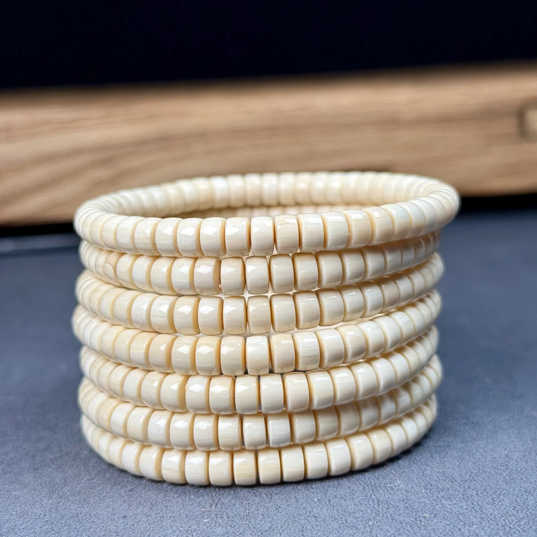 A044天然猛犸象牙芝士皮药片手串6×3mm 随机一条发货