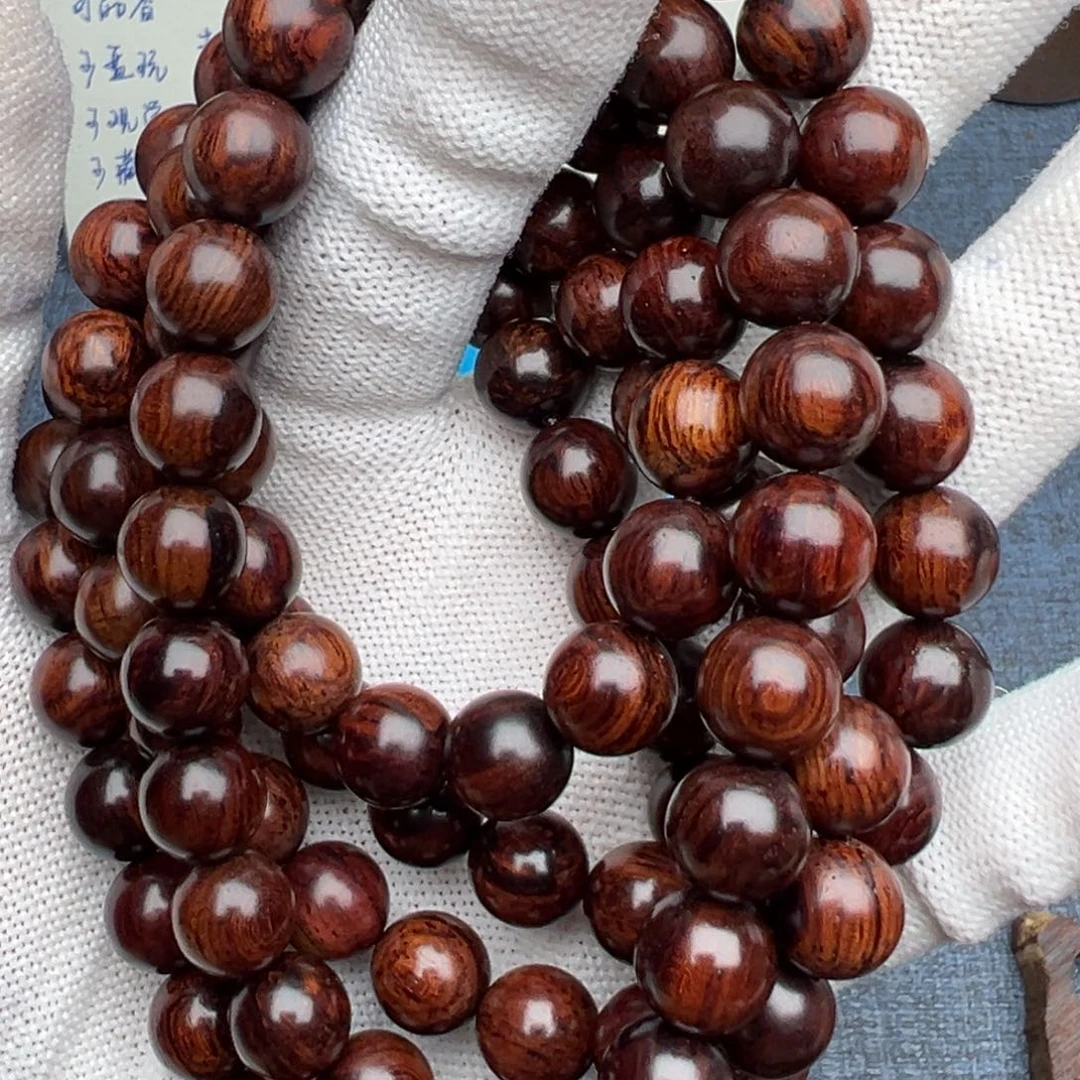 木蝎****0海南红降花梨公1.0黑金满纹多圈