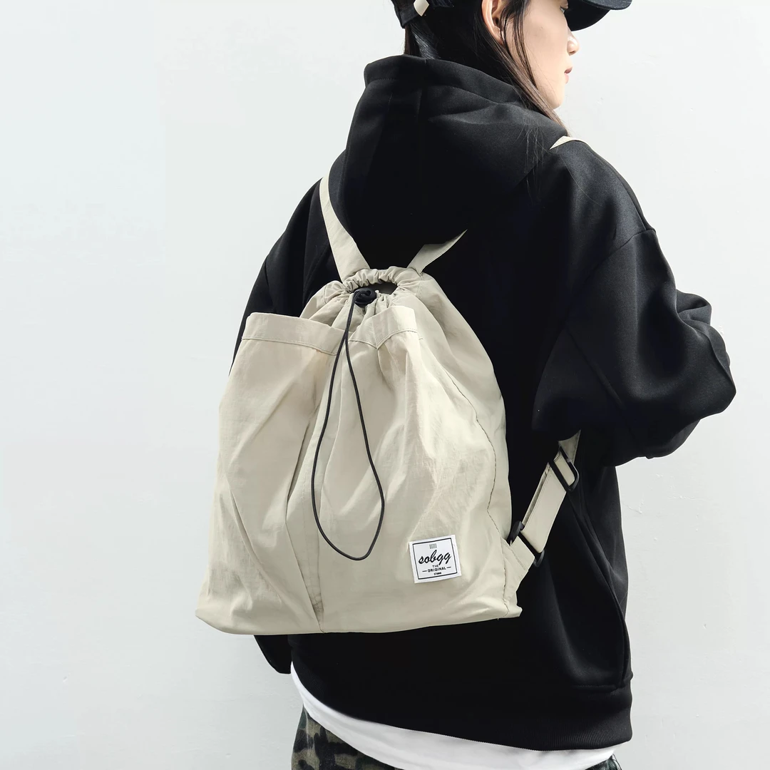 日系抽绳休闲防泼水尼龙布双肩包女慵懒背包中性大容量学生书包