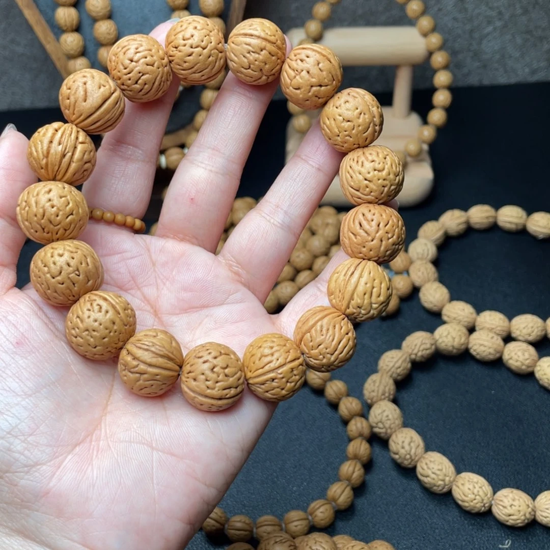 哈****?17野生灯笼滴流圆桃核手串