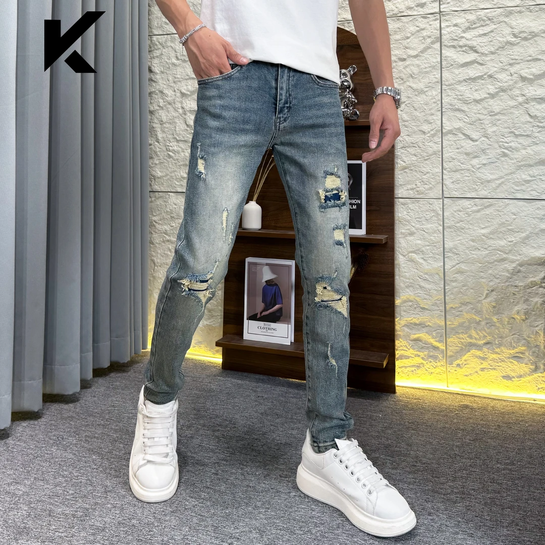 秋季新款高级设计款复古蓝贴布破洞时尚潮流白搭修身小脚牛仔长裤