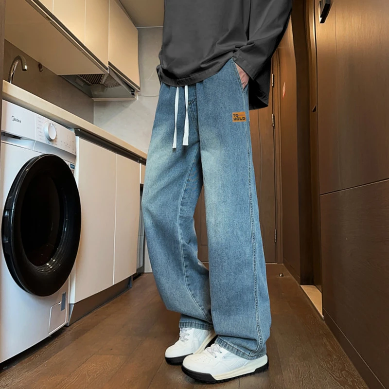 秋季新款青少年水洗牛仔裤渐变贴标设计宽松直筒男生百搭牛仔长裤