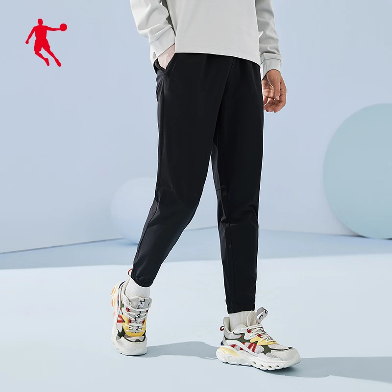 QIAODAN/乔丹运动长裤男春季透气梭织弹力束脚休闲跑步男士长裤