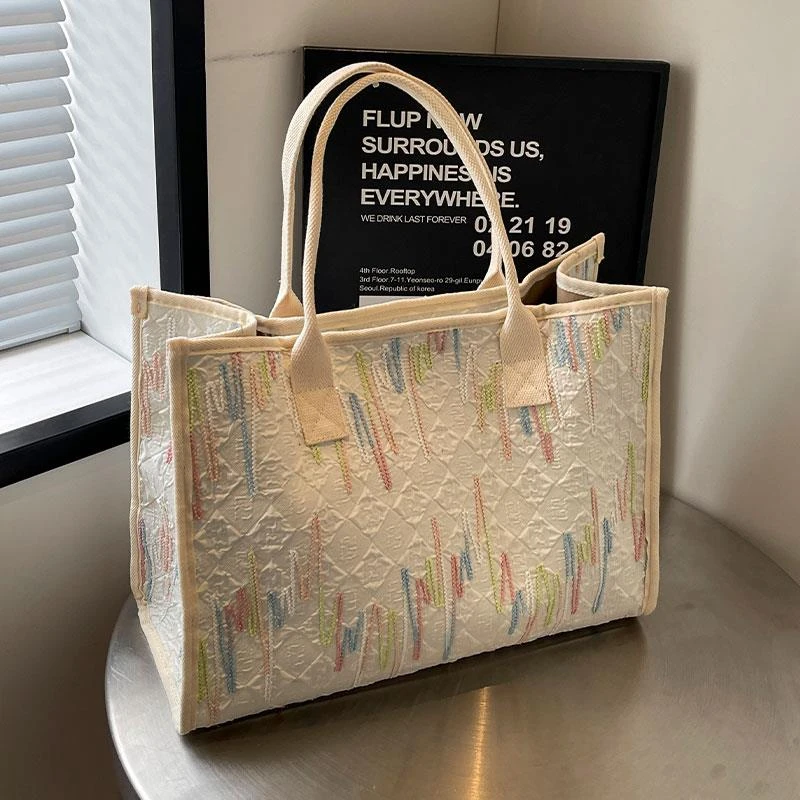 刺绣大容量通勤包女2025新款休闲手提购物袋单肩妈咪包百搭托特包