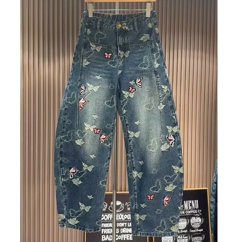 2025年秋季新款女装欧货宽松弯刀裤蝴蝶提花刺绣拼接水洗牛仔裤女