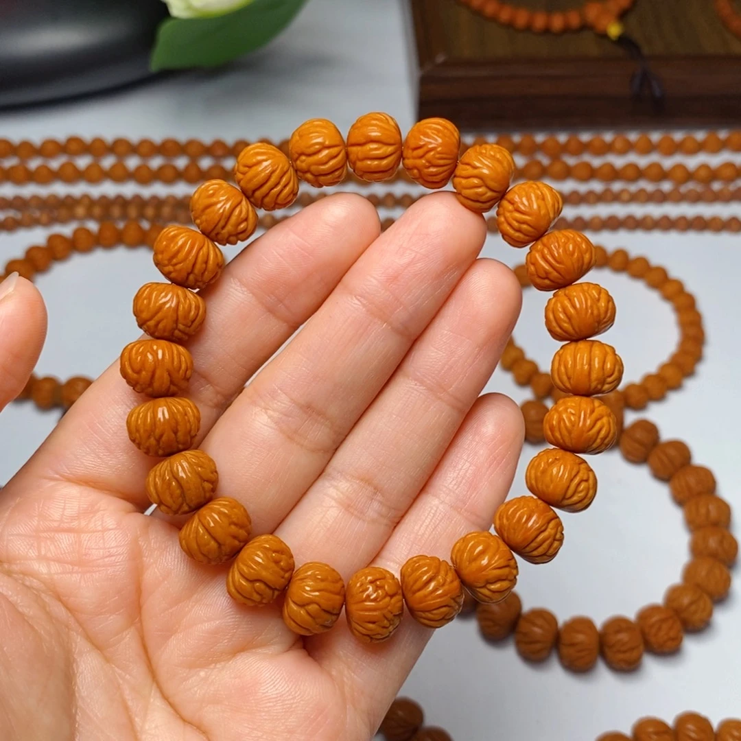 喜***乐手串桃核11mm野生凤羽聚宝盆