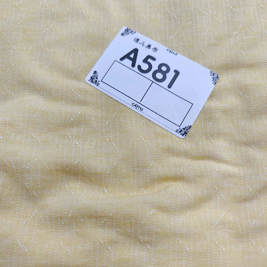 581小慕奶黄织花莱卡布料