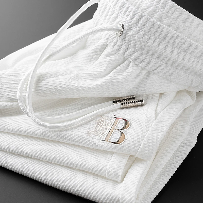 夏季薄款刺绣字母白色运动裤男修身束脚高端欧货休闲九分裤男士潮