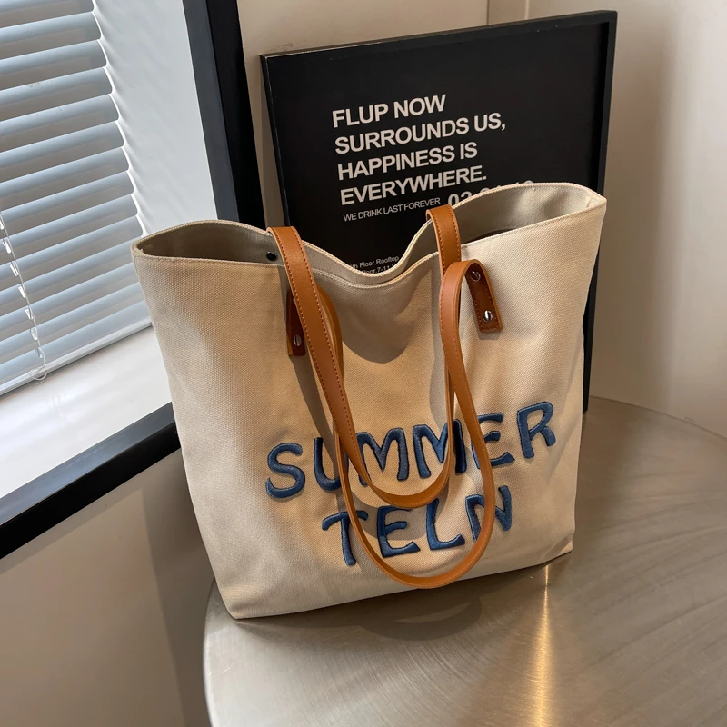 刺绣字母帆布包女2025新款大容量通勤托特包百搭单肩大学生上课包