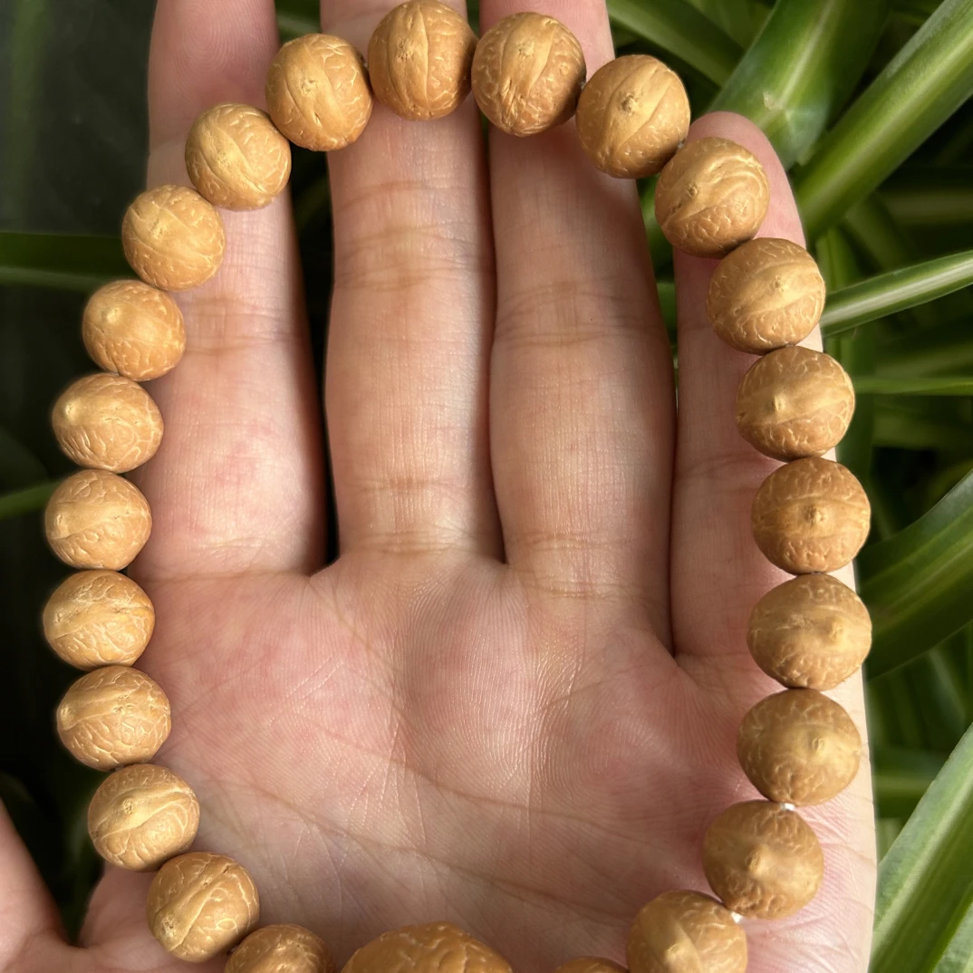 尼泊尔实心放漏 10.5足球圆粉皮平眼细纹浅腰线27颗实心凤眼手串