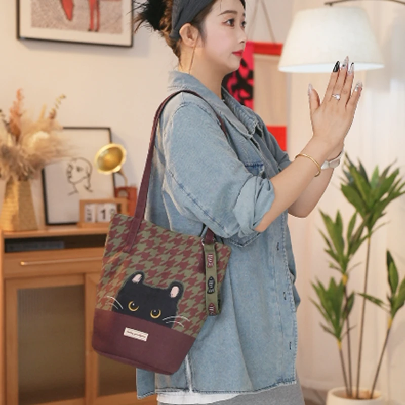 艺术鸭原创千鸟格小煤球细肩带水桶包通勤大容量单肩斜跨包女