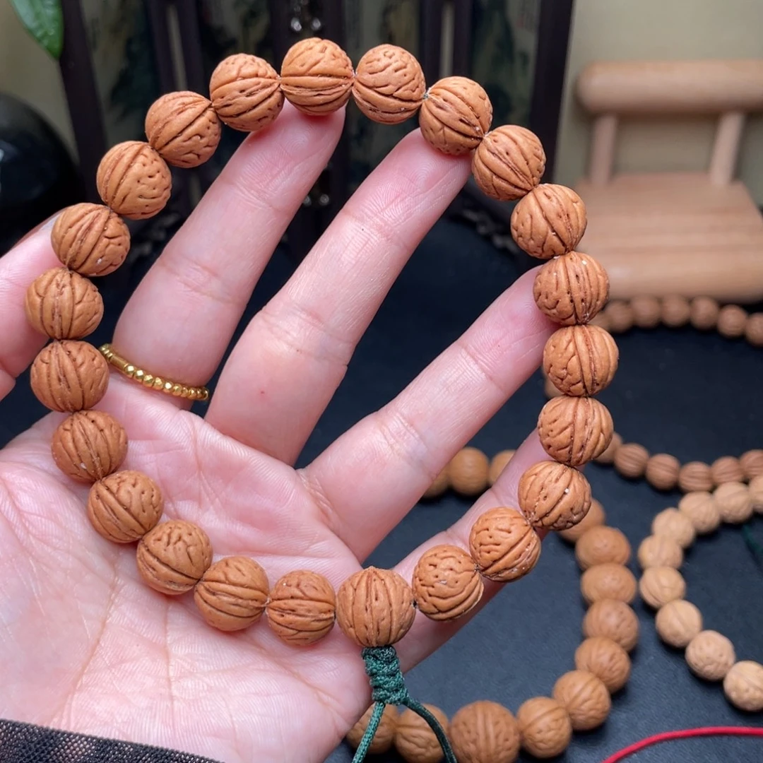 岁***人12加野生红皮桃核手持