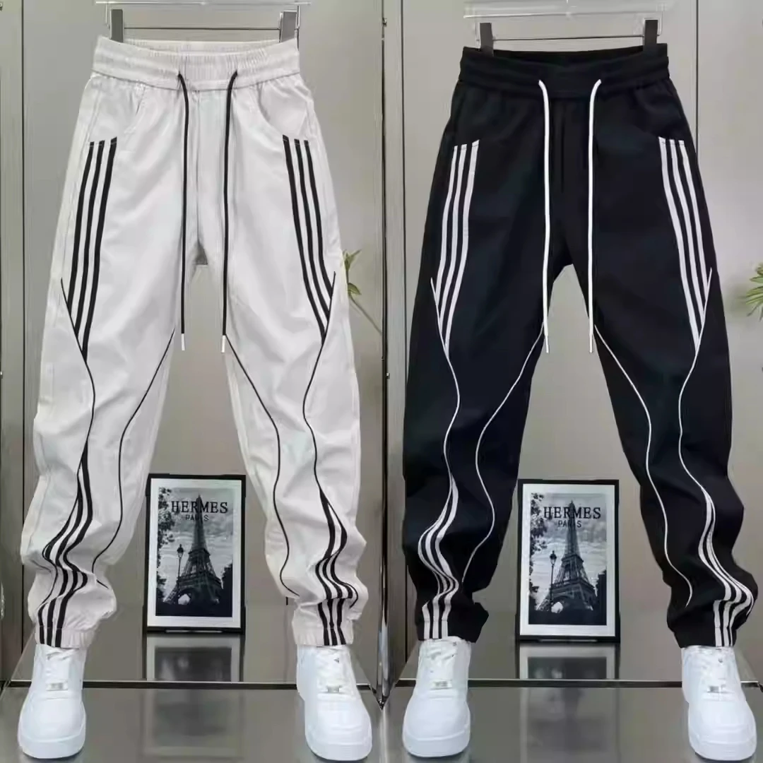 男生新款春秋季男款休闲裤男士束脚弹力松紧腰条纹拼接潮流哈伦裤