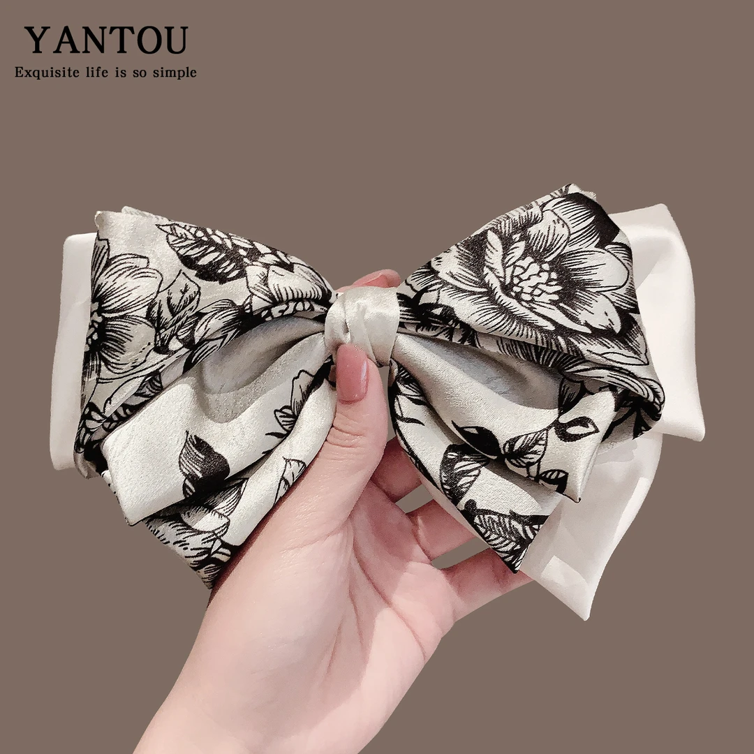 韩国东大门清冷图腾印花黑白拼色缎面蝴蝶结长飘带氛围感气质弹夹