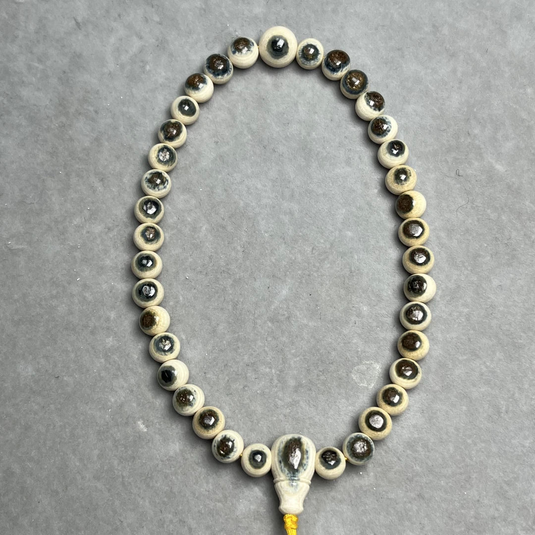 纯天然猛犸牙0.7+mm蓝眼圆珠手持一套