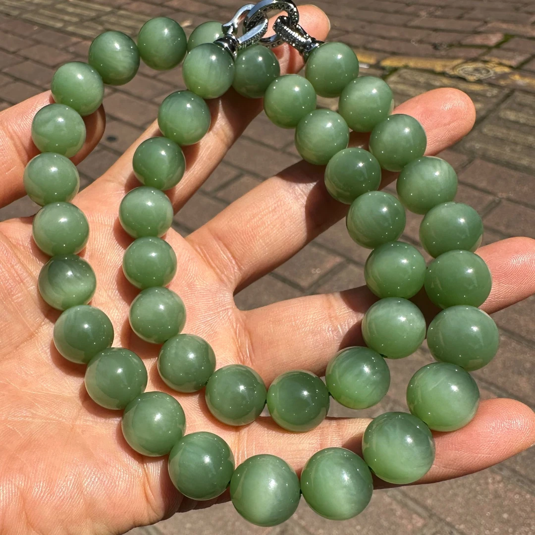 和田玉粉绿荧光活猫猫眼卡12毕业级