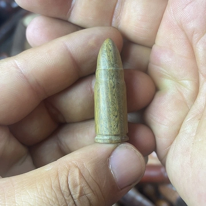 木瞌***欣绿檀手把件子弹头
