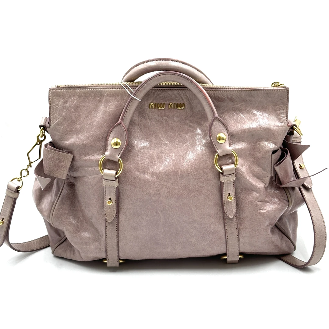 95新 MIU MIU/缪缪 miumiu粉色蝴蝶结机车包 奶粉色油蜡皮 98新